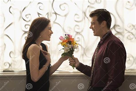 Man Giving Woman Flowers Stock Image Image Of Hair Flowers 2426069