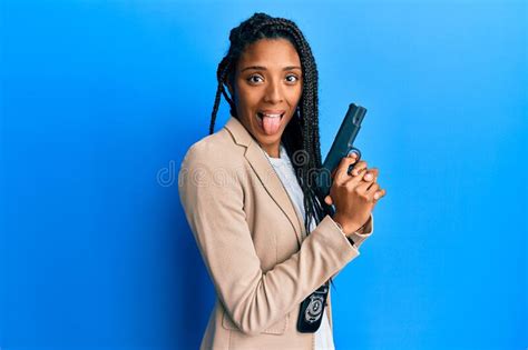 African American Police Woman Holding Gun Sticking Tongue Out Happy