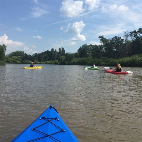 two people in kayaks paddling down the river