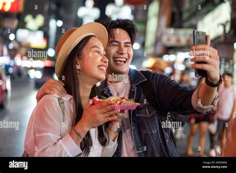 Asian Couple Tourist Backpacker Doing Selfie And Recording A Video Blog