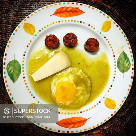 A Fried Egg In Green Sauce Cheese And Sausage In A Plate In A Home In Coyoacan Mexico City