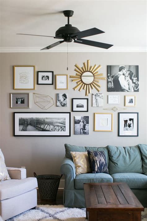 A Living Room Filled With Lots Of Framed Pictures On The Wall Next To A