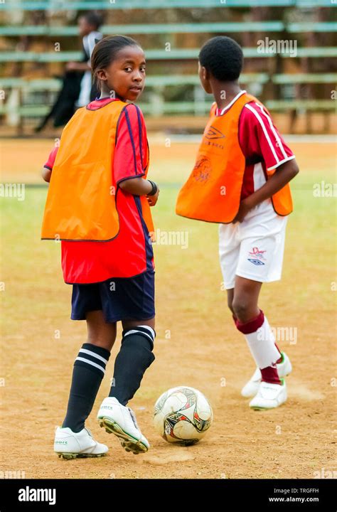 Johannesburg, South Africa - August 27 2009: Diverse children playing soccer football at school ...