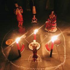 Candles Are Lit In The Middle Of A Table With Angels On It And Other