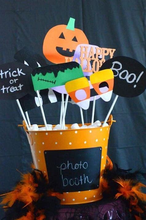 Halloween Photo Booth Props In A Bucket With Black And Orange Decorations On The Top