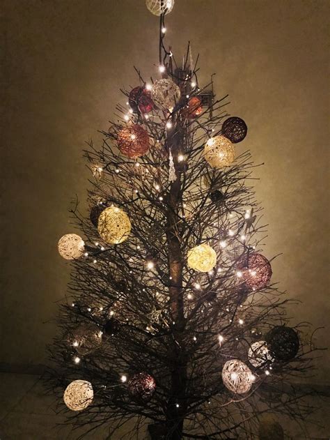 A Lit Up Christmas Tree With Many Balls On It S Branches And Lights