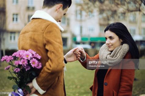 Young Man Surprising His Girlfriend On Valentines Day High Res Stock