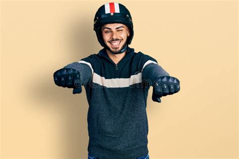 Young Hispanic Man With Beard Wearing Motorcycle Helmet Doing Driving