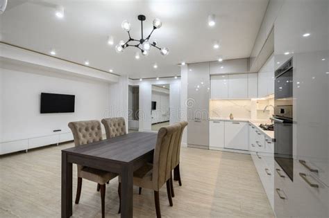 Huge White Luxury Kitchen in a Studio Apartment Interior Stock Photo