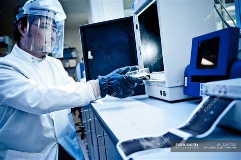 Scientist using equipment in lab — side view, mature man - Stock Photo ...