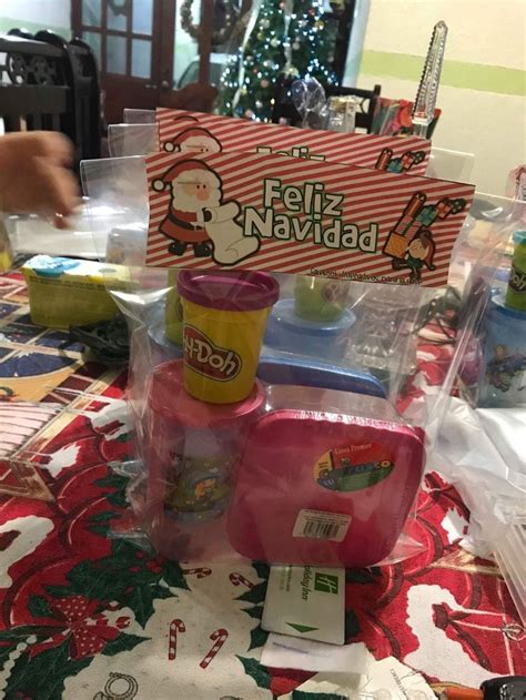 A Table Topped With Lots Of Toys And Other Items On Top Of A Red Blanket