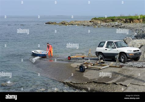 launching small boat from slipway Stock Photo - Alamy