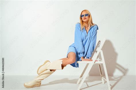 Indoor Fashion Portrait Of Beautiful Blonde Woman Wearing Trendy Blue Jersey Mini Dress With Zip