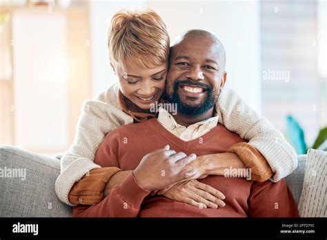 Marriage Hug And Portrait Of A Happy Couple On Sofa In The Living Room Of Their Modern Home