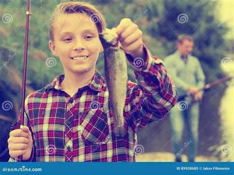 Relaxed Teenage Boy Holding Catch Freshwater Fish Stock Photos Free