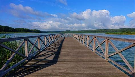 Premium Photo Wooden Bridge Over Water Against Sky