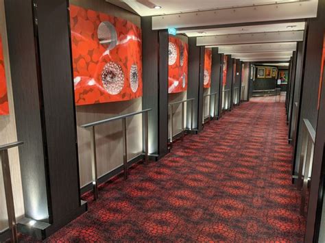 The Hallway Is Lined With Red Carpet And Black Walls