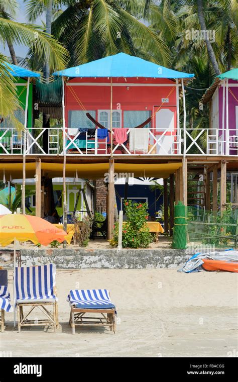 Colourful beach huts among the palm trees on Palolem beach, South Goa ...