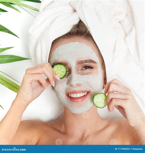 Portrait Of Beauty Woman Laying With Towel On The Head Cucumber On Her