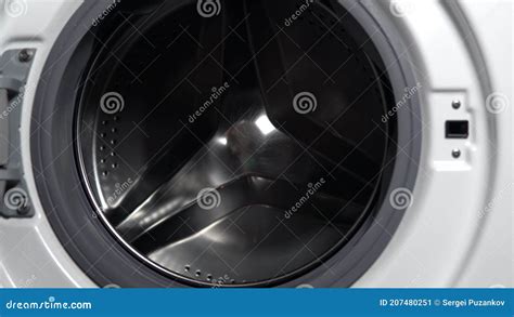 Girl Loads Dirty Things Into The Washing Machine Close Up Stock Image