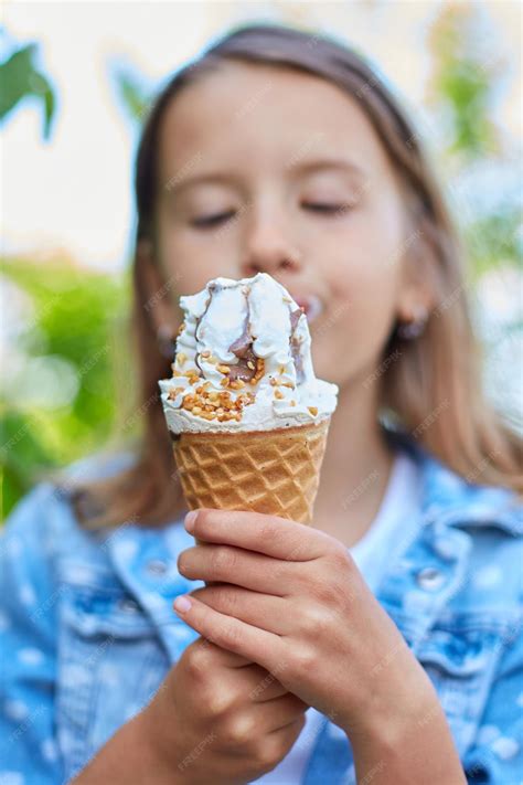 Premium Photo Cute Girl Liccking And Eating Italian Ice Cream Cone