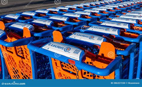 Close Up Of A Row Of Many Shopping Carts Branded With The Logo Of An E