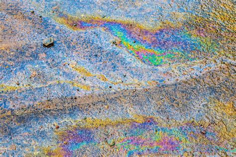 Colorful Fuel And Oil On An Asphalt Texture Showing Enviromental