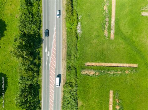 Drone top down view of a typical road in the UK. Showing a turn off into a nearby village. Stock ...