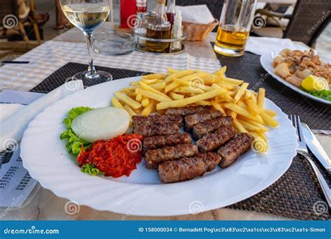 Traditional Croatian Balkan Cevapcici Dinner With Fies Ajvar And Onion