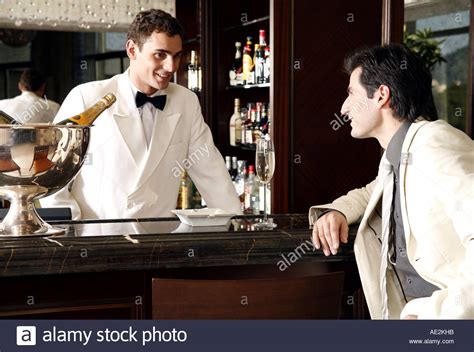 Man Sitting At A Bar Talking To The Bartender Stock Photo Alamy