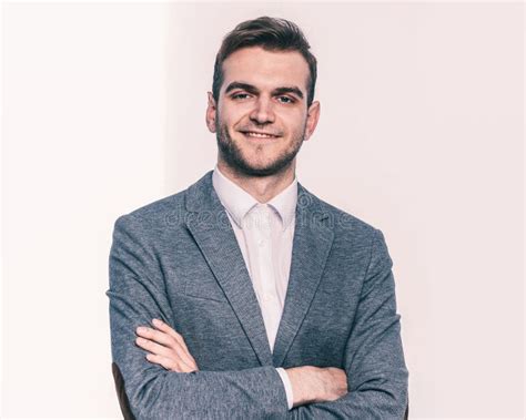 Portrait Of A Successful Manager In Glasses On A Light Background