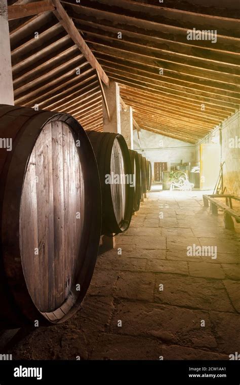 Red Wine Barrels Stacked In The Old Cellar Of The Vinery In Spain