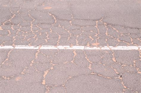 Premium Photo | Cracked asphalt road