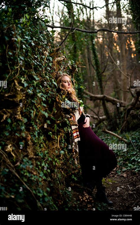 A Slim Blonde Woman Girl Alone In Woodland Autumn Afternoon Daytime Uk