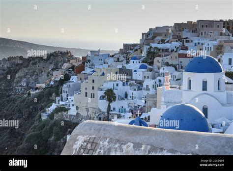 Santorini and its white houses with blue roofs Stock Photo - Alamy