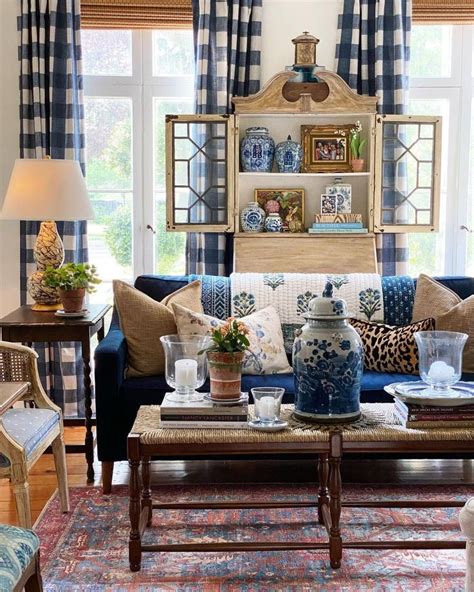 A Living Room With Blue And White Decor On The Walls Couches Coffee