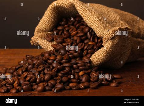 Coffee Beans In Bag On Table On Dark Background Stock Photo Alamy