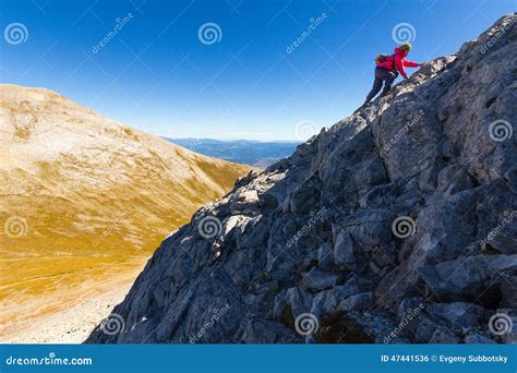 Climbing Up A Steep Rock Face On A Trail Using A Ladder. Royalty-Free ...