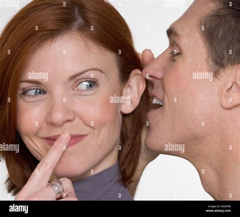 Man Whispering In Womans Ear