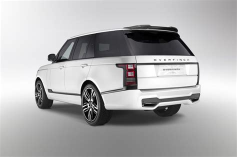 an all - white range rover is shown in this studio shot, with the rear ...