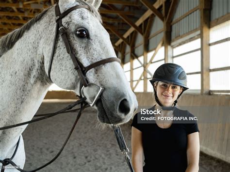 Young Female Trainer Prepping Her Horse Stock Photo - Download Image ...