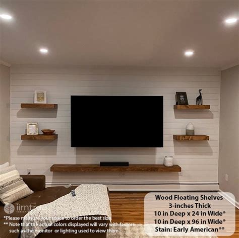 A Living Room With White Painted Walls And Wood Floating Shelves On The