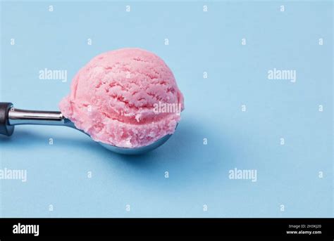 Ice cream scoop on blue background Stock Photo - Alamy