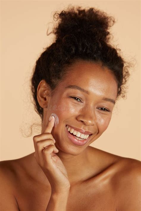 Body Skin Care Smiling Black Woman Applying Body Cream Portrait Stock