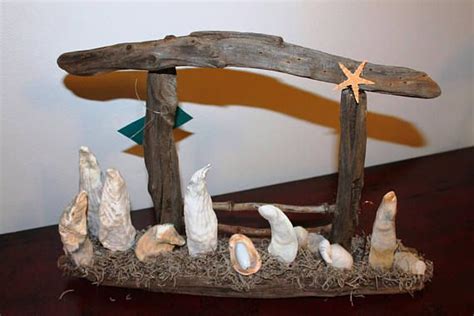 A Nativity Scene Made Out Of Driftwood And Seashells