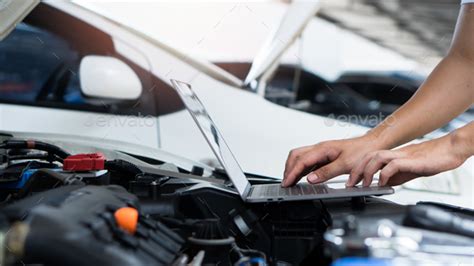 Car Mechanic Using Laptop Computer Examining Tuning Fixing Repairing