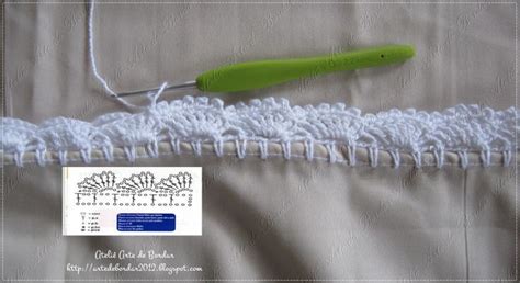 A Crochet Hook Is Hooked Up To The Side Of A White Piece Of Fabric