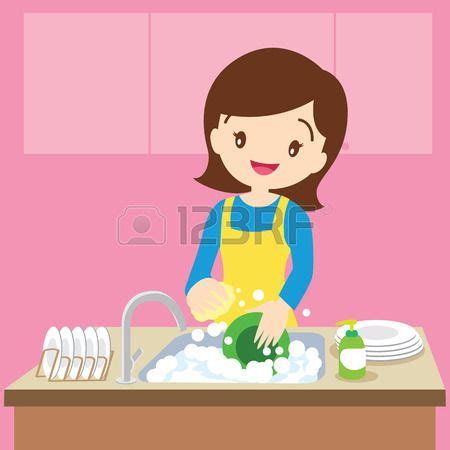 A Woman Washing Dishes In The Kitchen