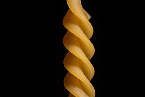 Premium Photo Spiral Pasta Close Up On Black