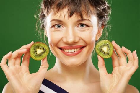 Premium Photo Young Smiling Woman Holding Kiwi